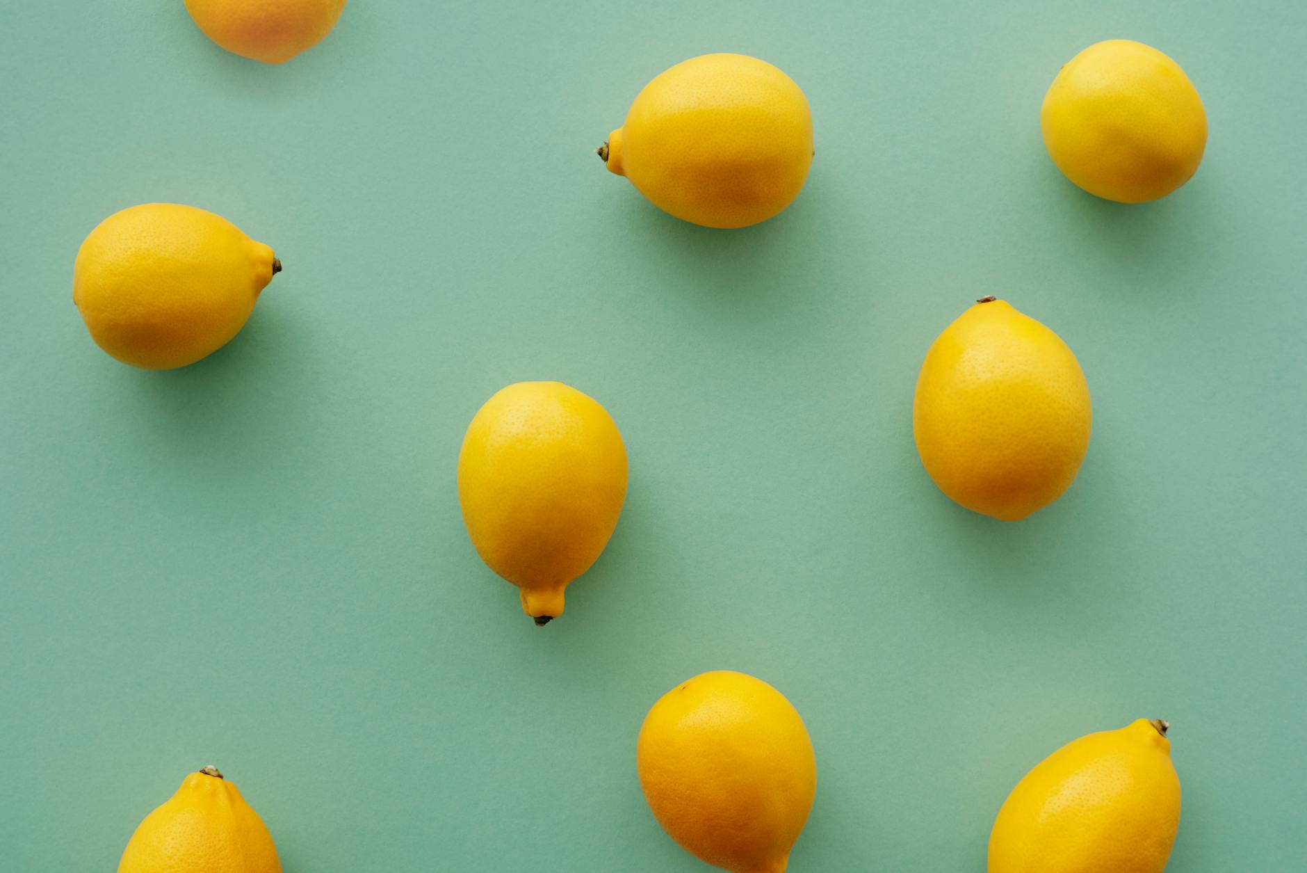 Bright yellow lemons arranged on a pastel background, symbolizing the lemon sucker vibrator brand