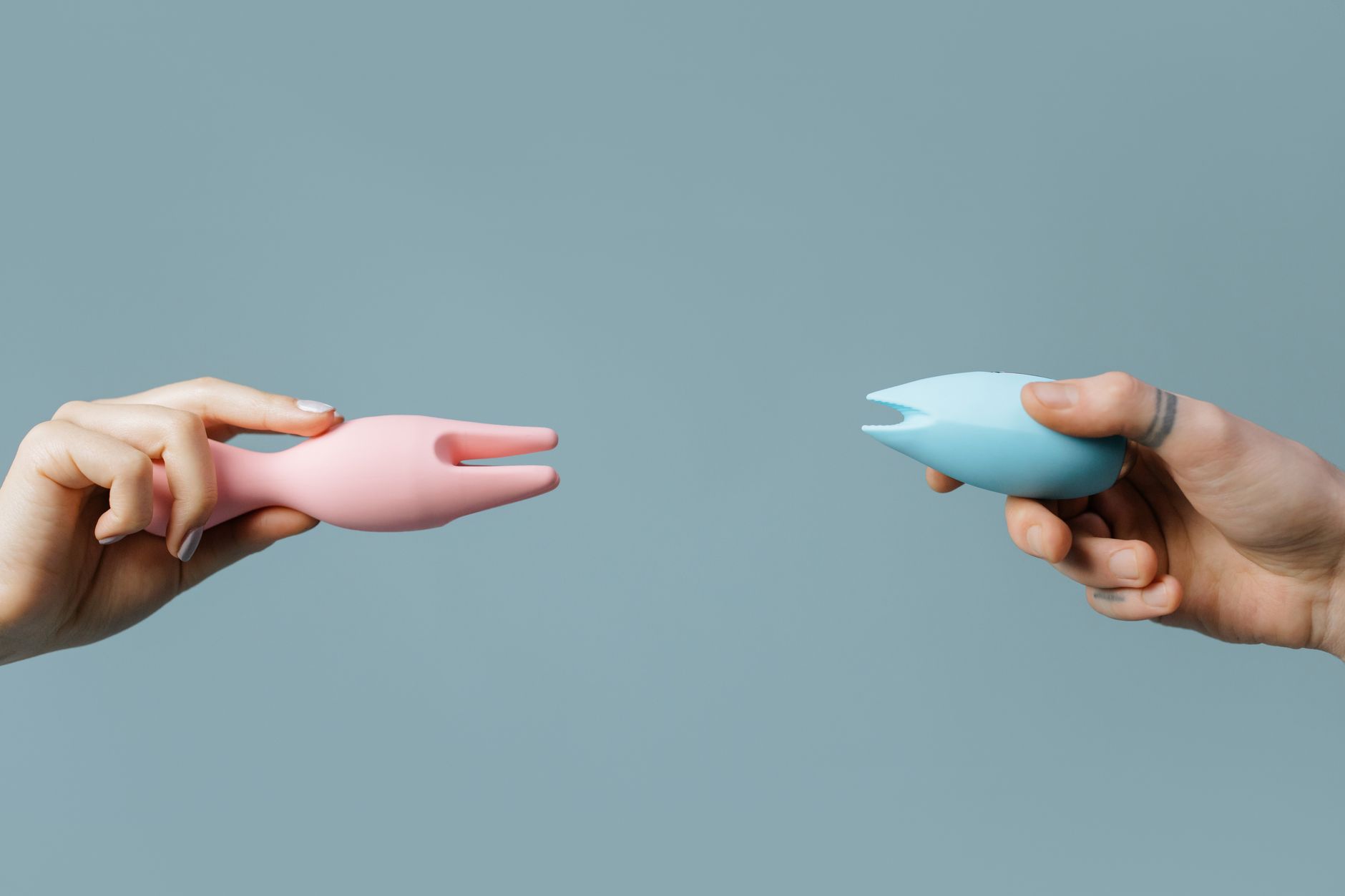 Person holding a blue vibrator against a purple background, symbolizing reconnection and self-touch