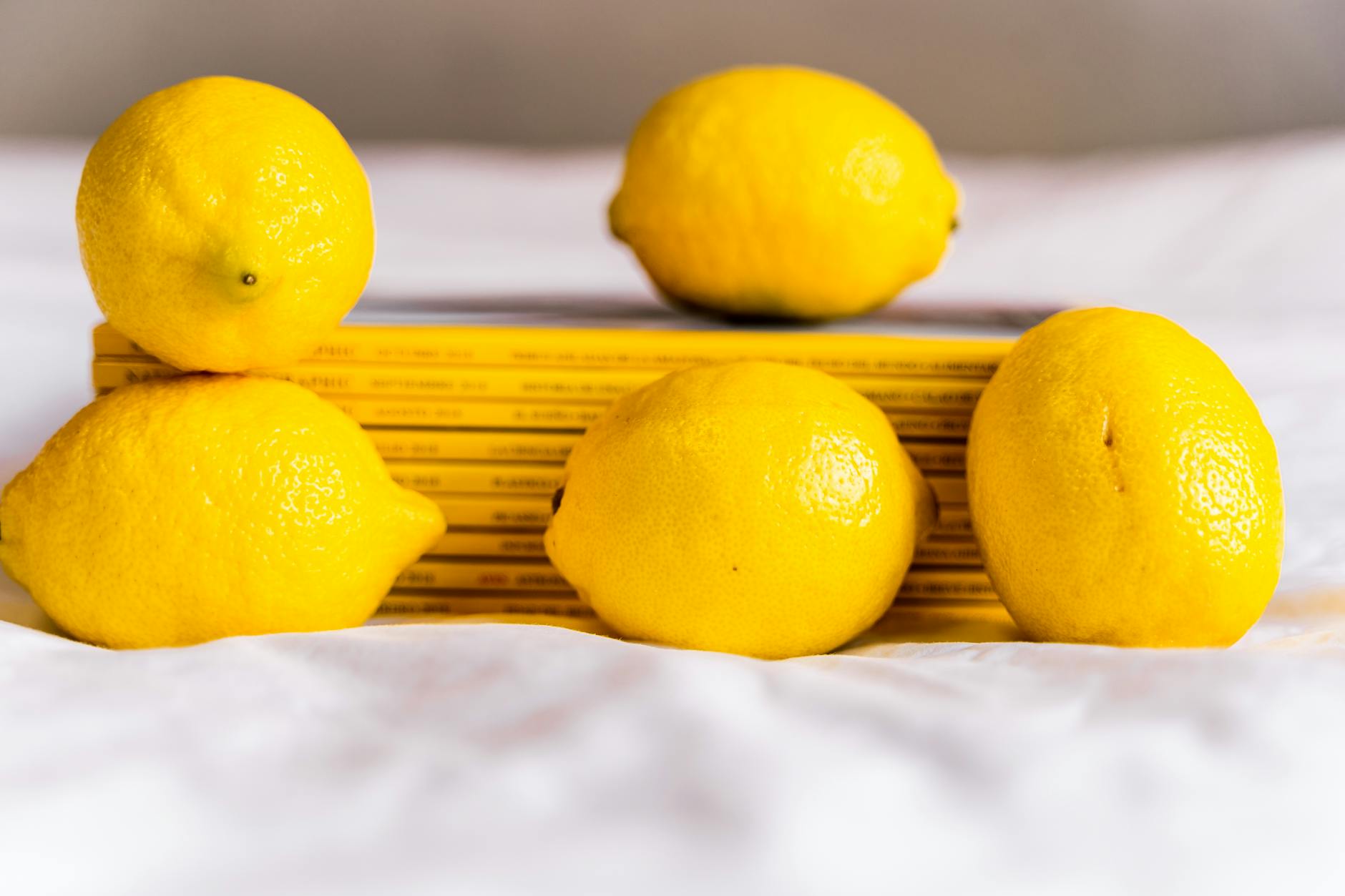 Close-up of a woman holding a fresh lemon, representing renewed vitality and pleasure